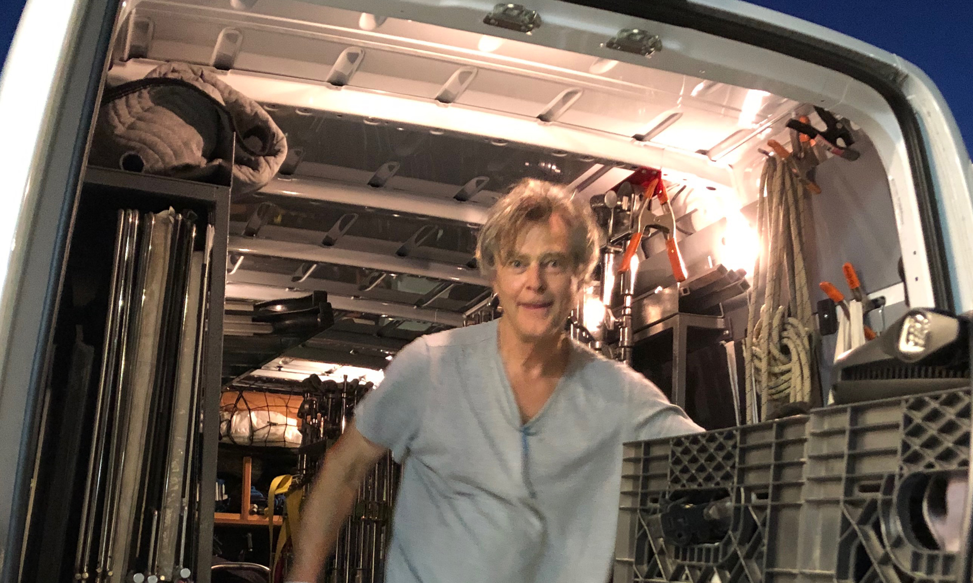Shot of Jim Fisher, Owner, Operator and Gaffer in the back of his 3-ton Sprinter Van chock full of gear and equipment. Gaffer Lighting Truck Dallas